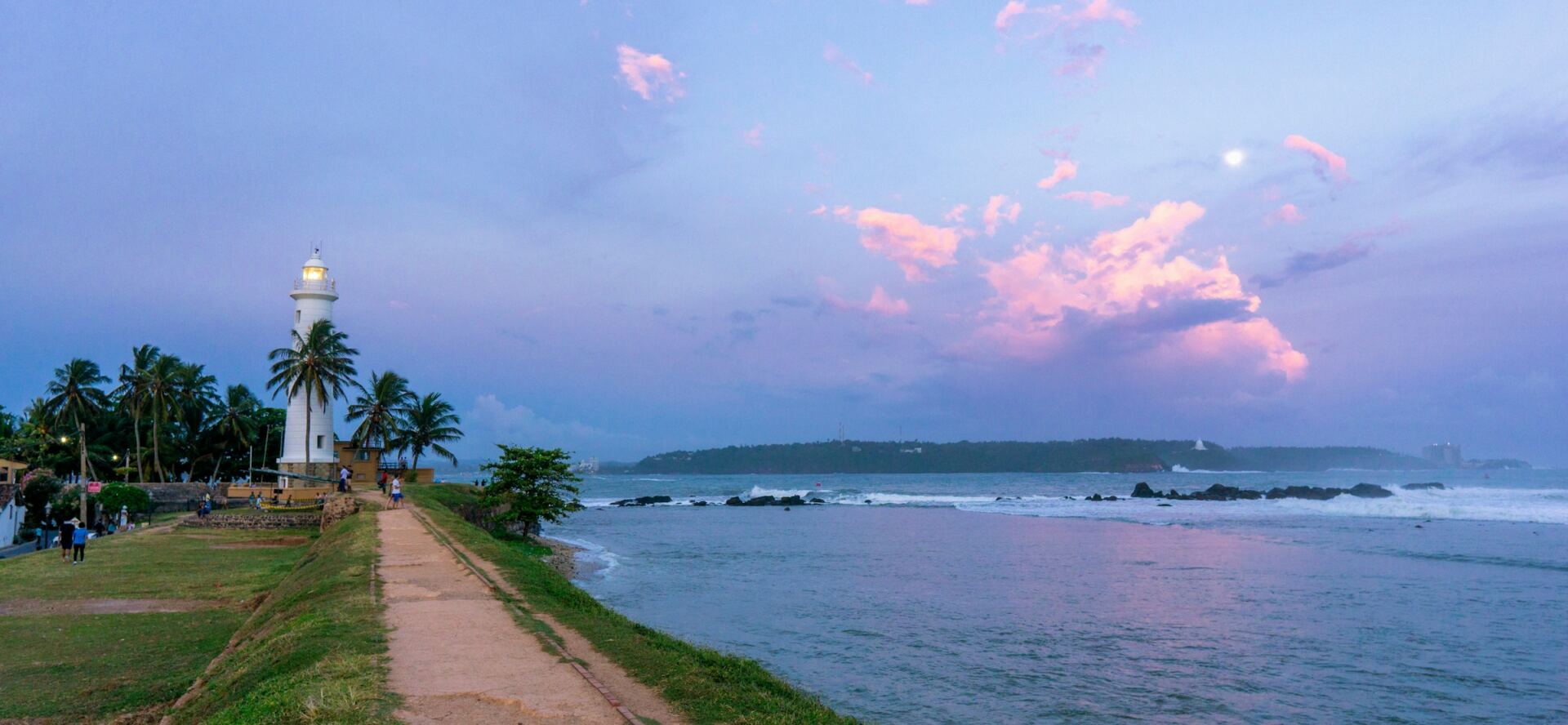 White lighthouse in Galle Fort beside the ocean